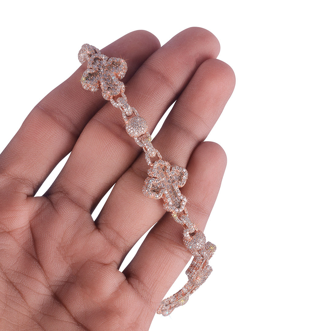 Rose gold bracelet on a hand against a white background