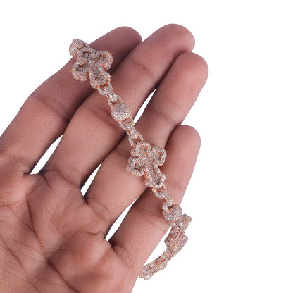 Rose gold bracelet on a hand against a white background