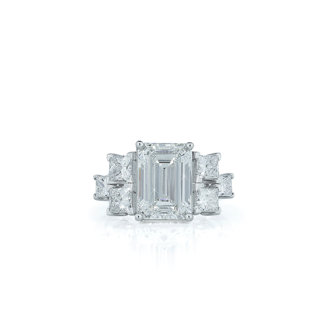 Emerald cut diamond center ring with side diamonds (three-stone or multi-stone ring). Diamlux Fine Jewelry